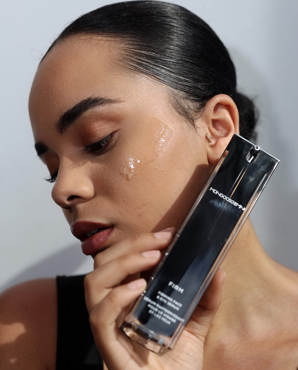 Model with firm serum applied to face